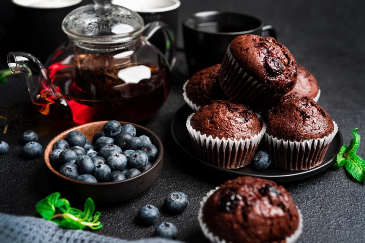 Decadent Delights: Chocolate Muffins with Red Fruits and White Sugar Sprinkle